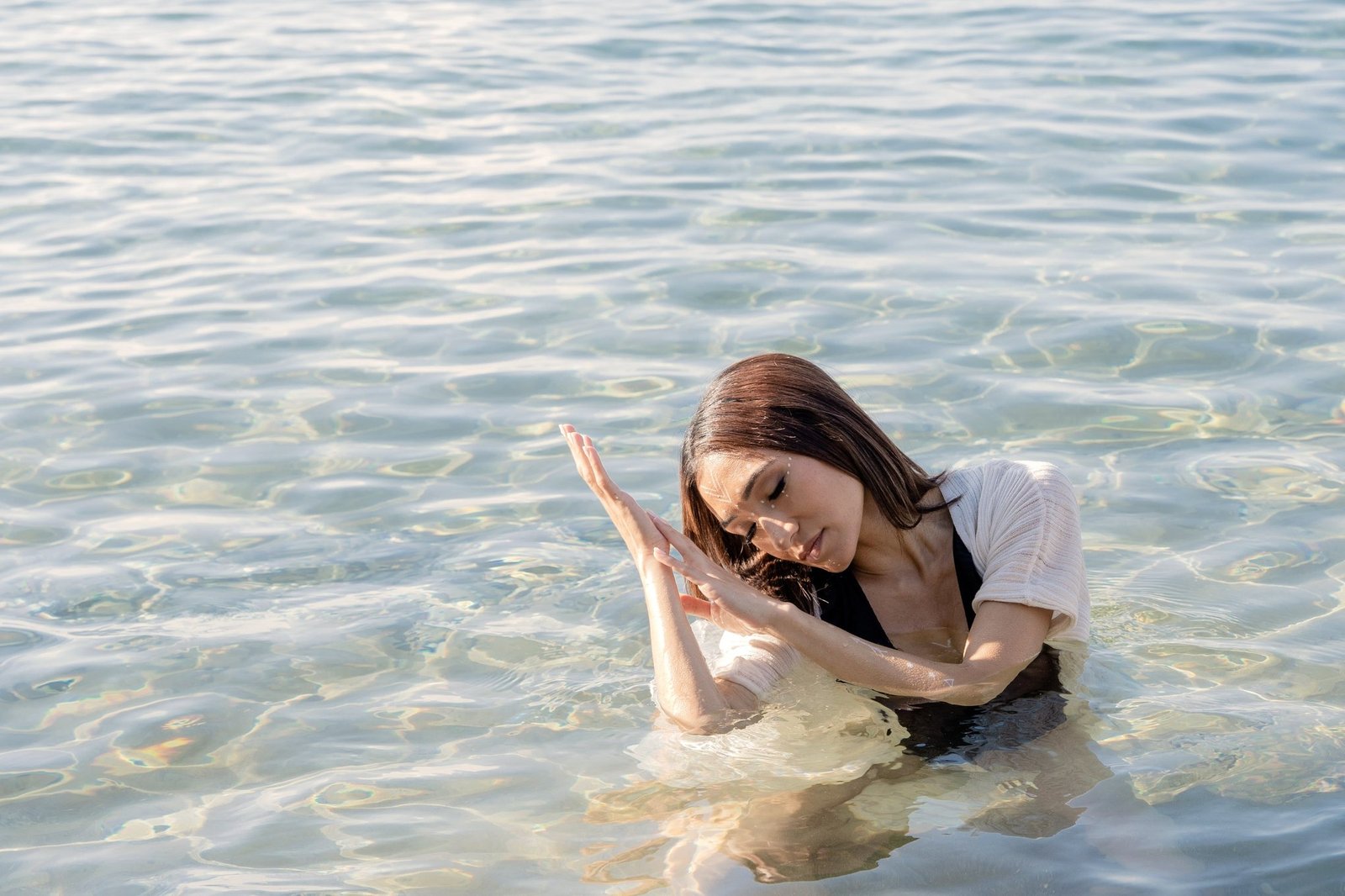 Body Recalibration — Mona Hassan in water, ritual gesture